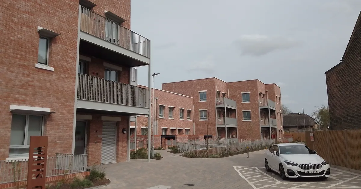 A new-build block of flats around a courtyard car park in Haringey, London.