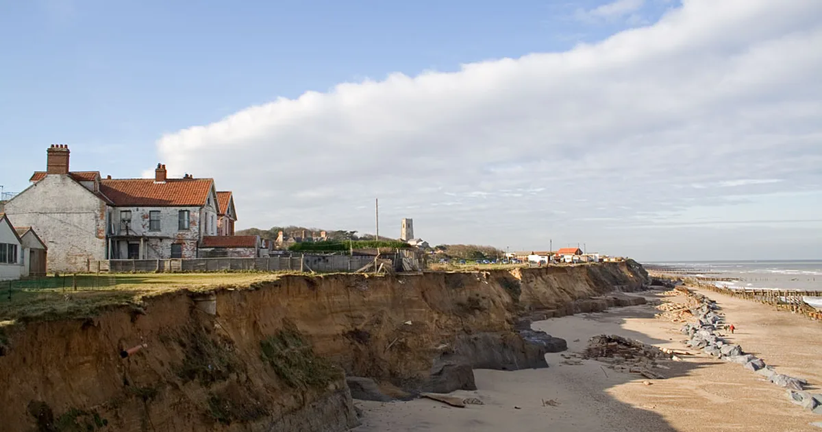 Cliff-top houses at Happisburgh, Norfolk, close to the edge after years of coastal erosion.