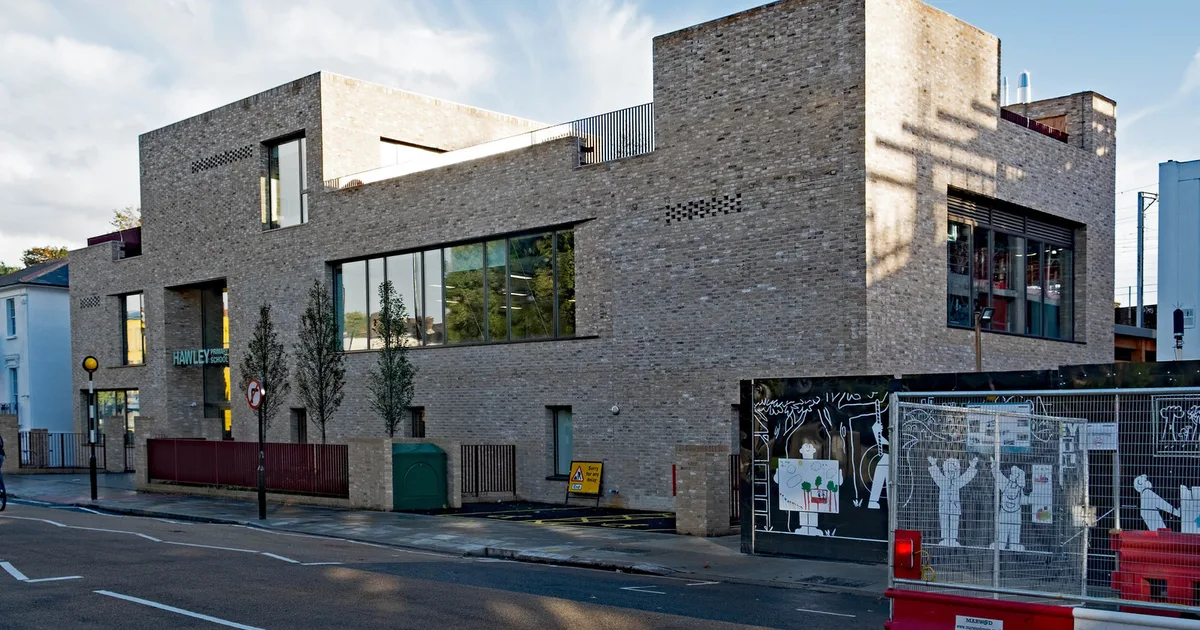 Hawley Primary School, a modern brick-built primary school building in Kentish Town, London, seen from the street.