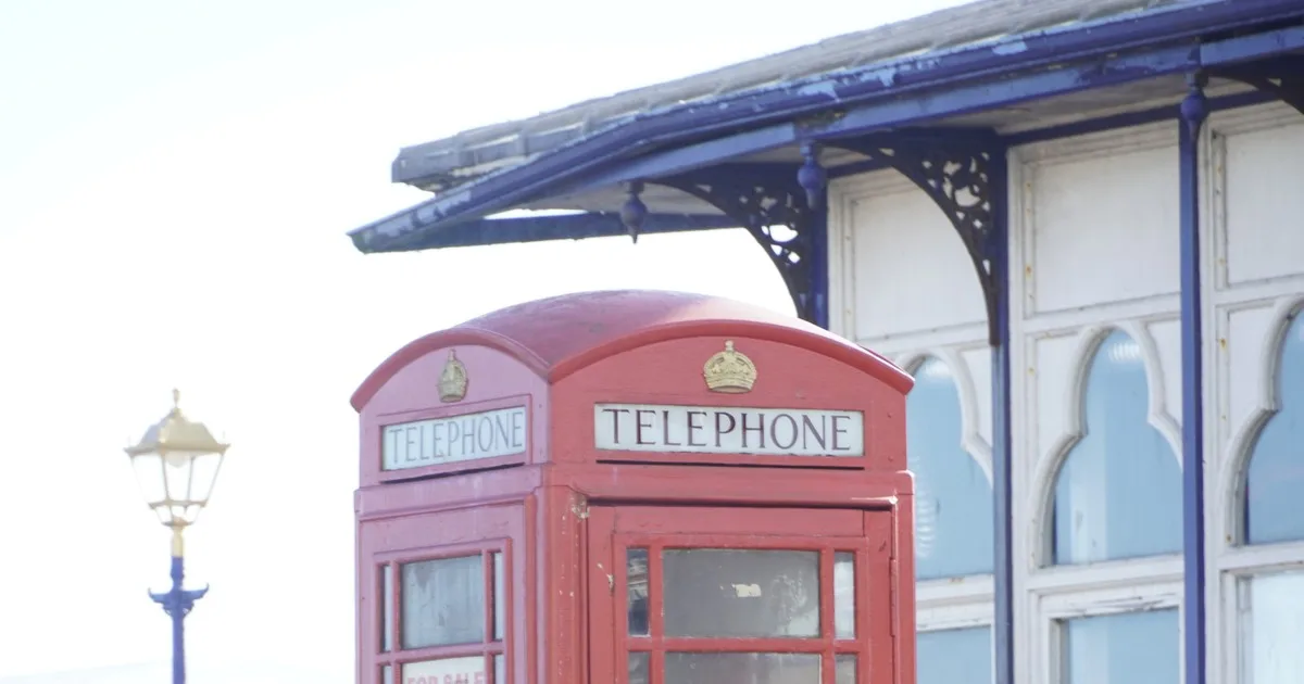 A red K6 telephone kiosk on the seafront at Eastbourne, East Sussex.