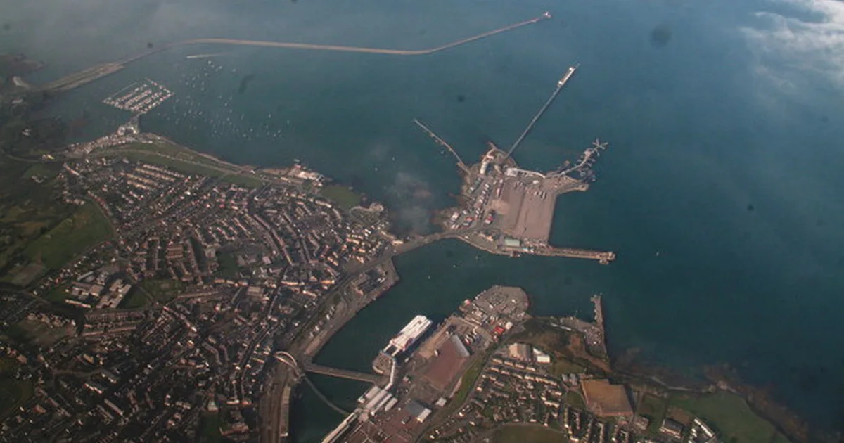 Aerial view of Holyhead, Anglesey, showing the town, harbour and ferry port breakwater extending into the Irish Sea.