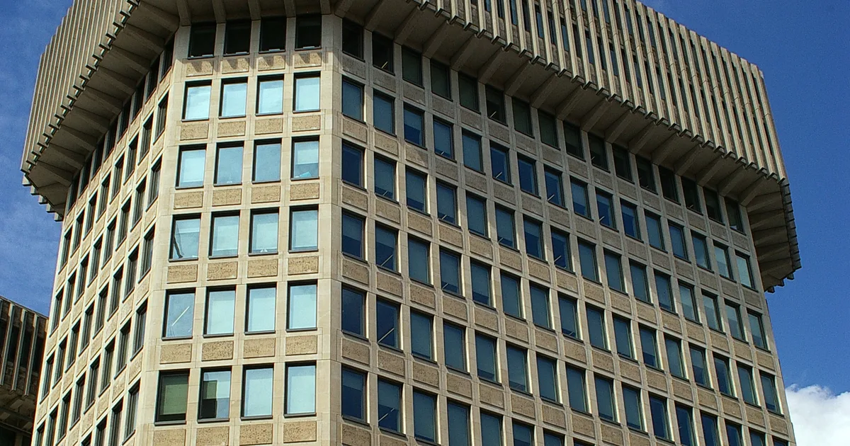 102 Petty France, the Ministry of Justice's headquarters building in Westminster, seen from below against a blue sky.