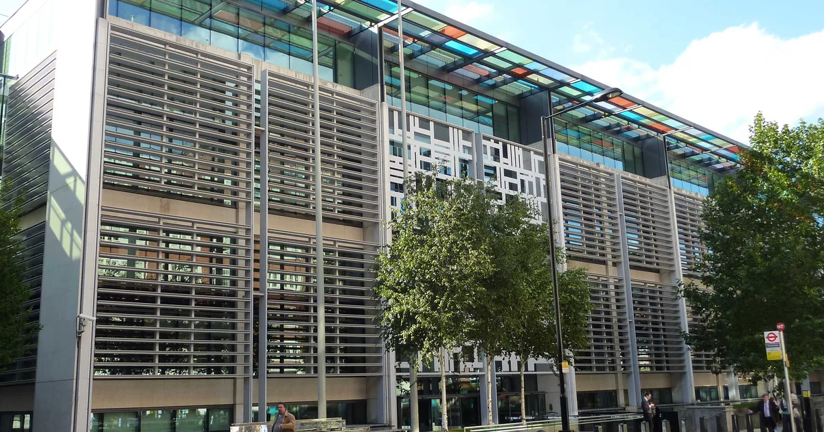 2 Marsham Street, the Home Office headquarters building in Westminster, London, photographed from street level with its glass canopy and perforated steel facade.