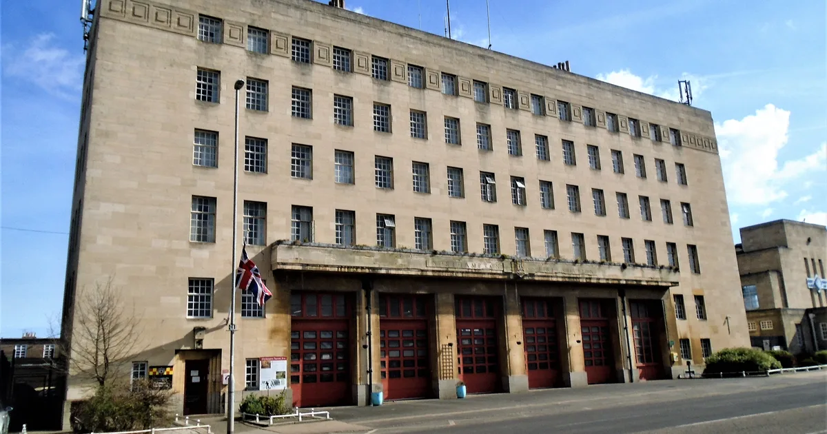 Northampton Fire Station, a 1930s Art Deco building with red engine-bay doors, photographed from the street.