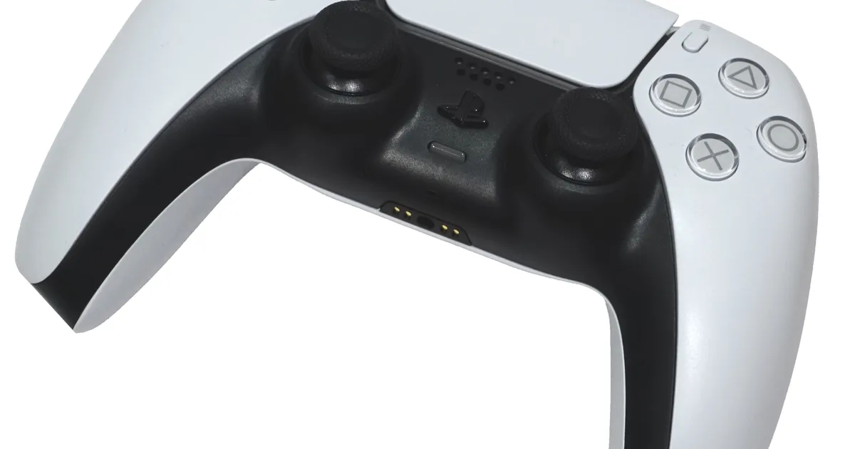 A white PlayStation 5 DualSense controller, photographed against a plain background.