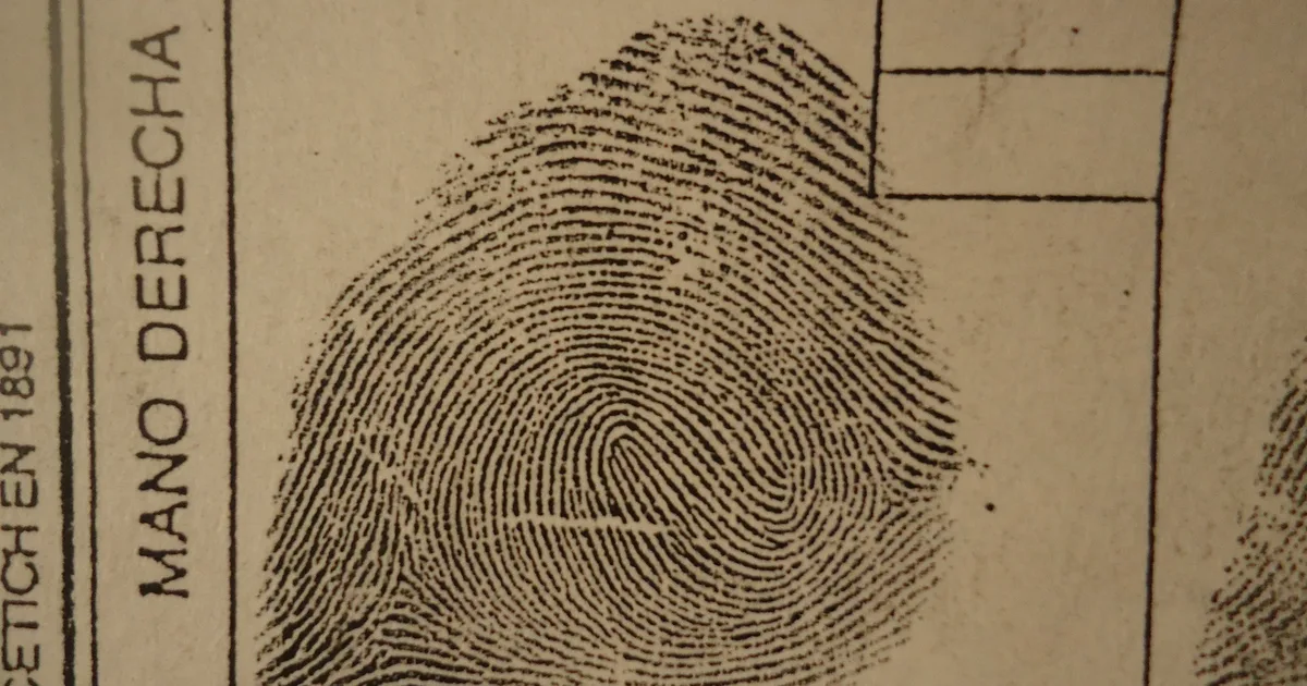 A historic inked fingerprint classification card, right thumb, showing the ridge whorl in close detail.