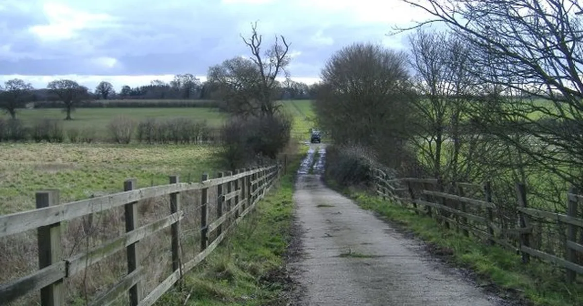 An organic farm in Broomfield, Wiltshire, England, seen from the M4 overbridge, with fields and farm buildings visible.
