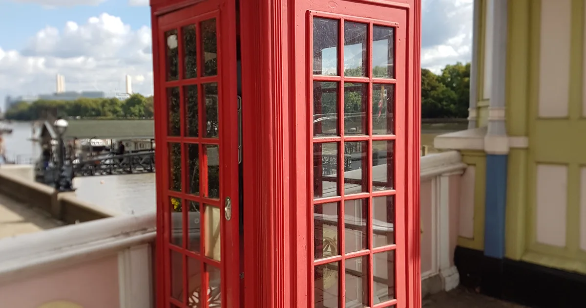 A red K2 telephone box on Albert Bridge, London.