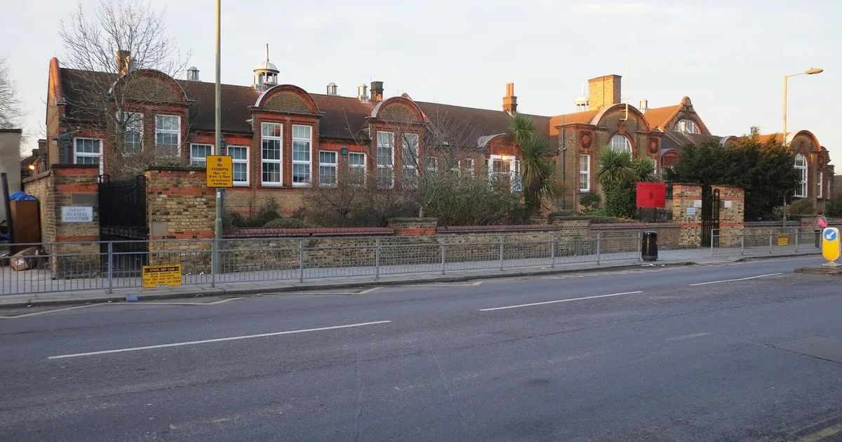 Manorside Primary School, a red-brick Victorian board school building behind railings on Squires Lane, London Borough of Barnet.