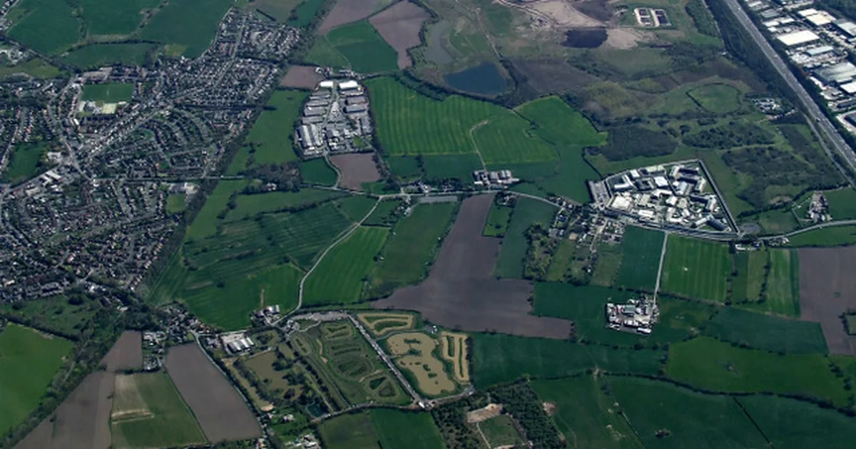 An aerial view of HMP Risley, showing its residential wings and perimeter fencing.